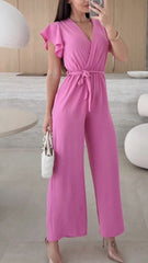Letni dopasowany kombinezon z szerokimi nogawkami i dekoltem w serek