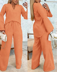 Zestaw 2 szt. Topu z wycięciem pod szyją i asymetrycznym obszyciem oraz spodni z prostymi nogawkami ze sznurkiem